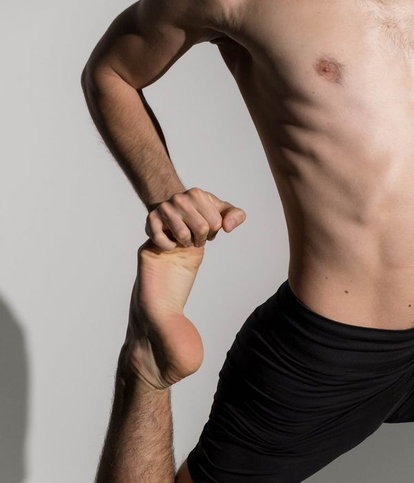 Person performing a deep stretching yoga pose, showing flexibility.